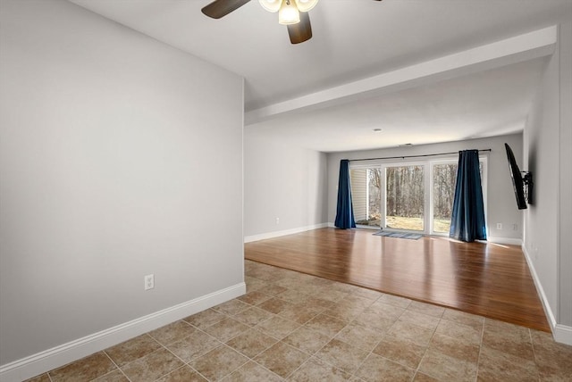 empty room with a ceiling fan, baseboards, and light wood-type flooring