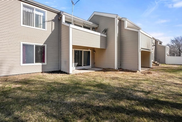 back of house with a yard and fence