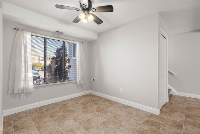 spare room featuring visible vents, baseboards, and ceiling fan