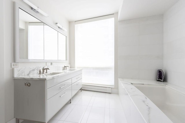 bathroom featuring double vanity, tile patterned flooring, a bathtub, and a sink