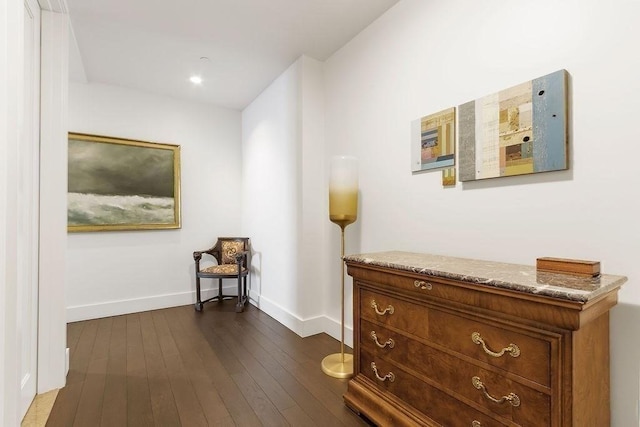 corridor featuring recessed lighting, baseboards, and dark wood-style flooring