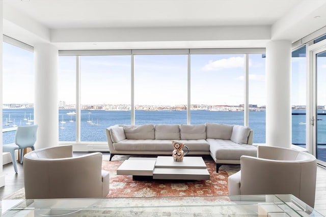 living room with wood finished floors and a water view