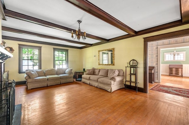 21 Otis St, Milton, MA 02186 - living room featuring a chandelier, hardwood / wood-style flooring, beam ceiling, and baseboards
