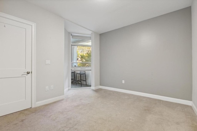 unfurnished room with light carpet