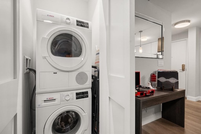 washroom featuring wood-type flooring and stacked washer and dryer