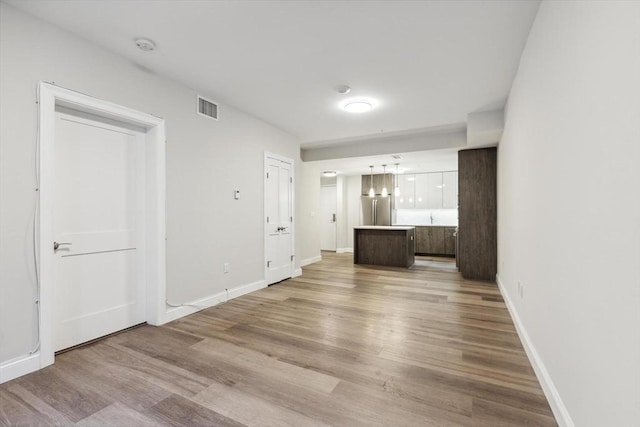 unfurnished living room featuring light wood-type flooring