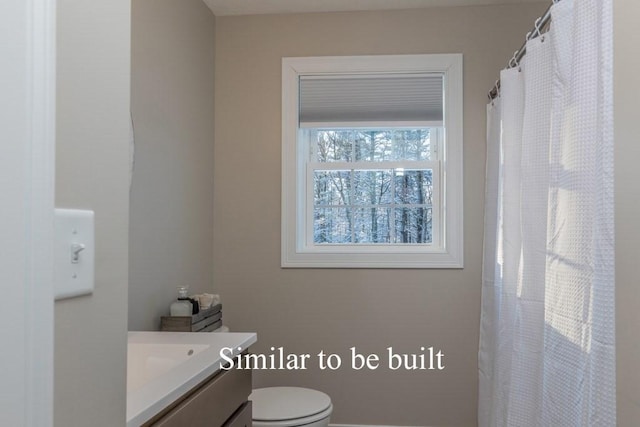 bathroom featuring vanity and toilet