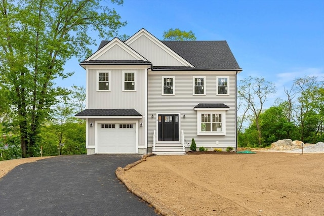10 Sylvan Hill Xing, Haverhill, MA 01832 - view of front of house featuring driveway, a shingled roof, an attached garage, and board and batten siding