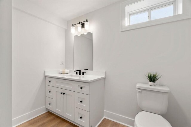 10 Sylvan Hill Xing, Haverhill, MA 01832 - bathroom featuring baseboards, vanity, toilet, and wood finished floors