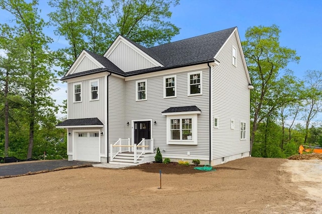 10 Sylvan Hill Xing, Haverhill, MA 01832 - view of front facade with board and batten siding, driveway, a garage, and a shingled roof
