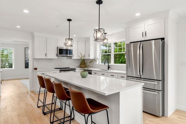 10 Sylvan Hill Xing, Haverhill, MA 01832 - kitchen featuring appliances with stainless steel finishes, a sink, tasteful backsplash, white cabinets, and recessed lighting