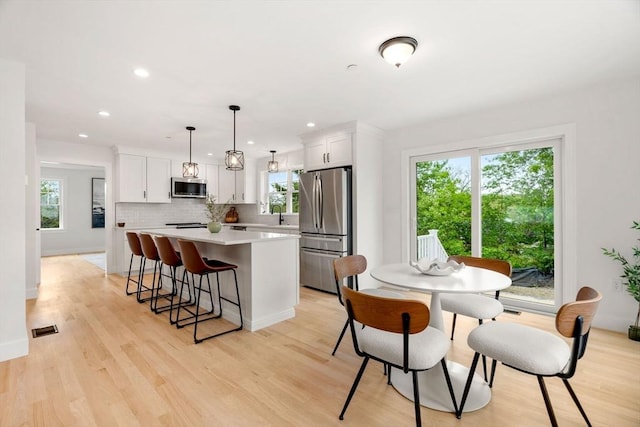 10 Sylvan Hill Xing, Haverhill, MA 01832 - kitchen featuring appliances with stainless steel finishes, a center island, light countertops, white cabinets, and recessed lighting