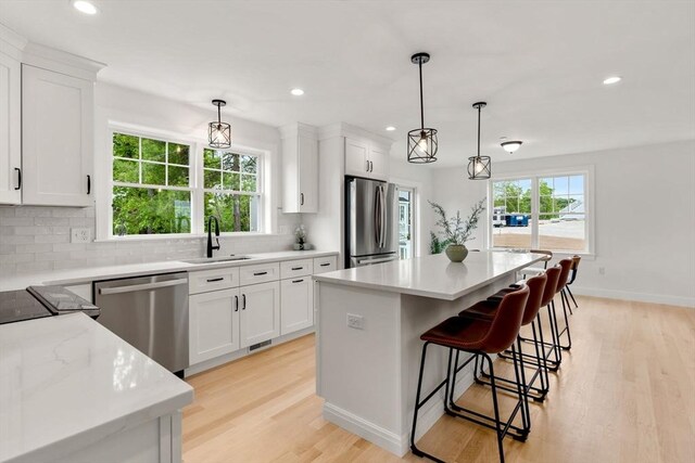 10 Sylvan Hill Xing, Haverhill, MA 01832 - kitchen with appliances with stainless steel finishes, a sink, light wood finished floors, a kitchen island, and recessed lighting