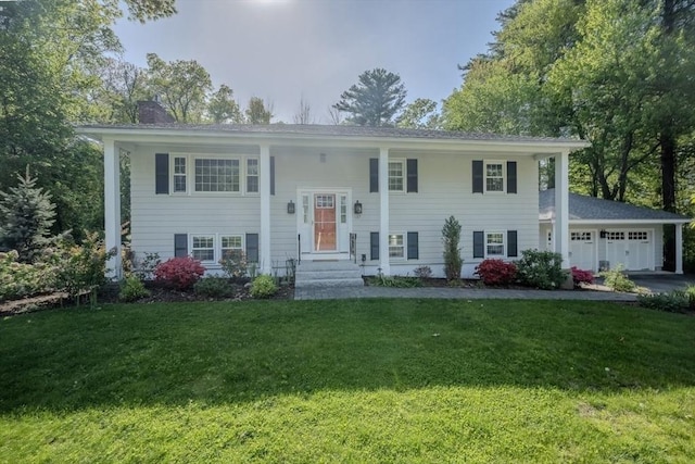 137 Naugler Ave, Marlborough, MA 01752 - bi-level home featuring a garage, a chimney, a front yard, and driveway
