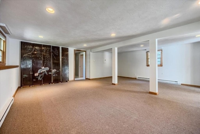 137 Naugler Ave, Marlborough, MA 01752 - basement featuring a baseboard radiator, recessed lighting, carpet, baseboards, and a textured ceiling