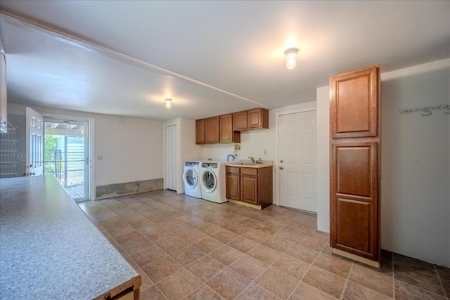 137 Naugler Ave, Marlborough, MA 01752 - kitchen with separate washer and dryer, light countertops, a sink, and brown cabinetry