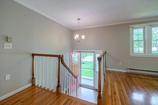 137 Naugler Ave, Marlborough, MA 01752 - staircase featuring wood finished floors, a chandelier, baseboards, ornamental molding, and a baseboard heating unit