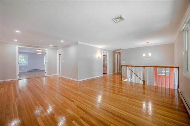 137 Naugler Ave, Marlborough, MA 01752 - unfurnished room featuring a chandelier, light wood-style floors, a baseboard heating unit, crown molding, and baseboards