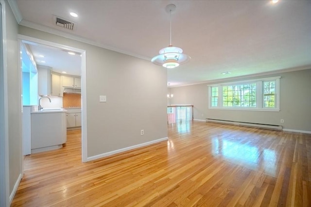 137 Naugler Ave, Marlborough, MA 01752 - empty room featuring a baseboard radiator, ornamental molding, light wood finished floors, baseboards, and recessed lighting