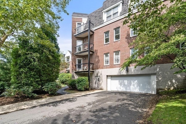 97 Anderer Ln Unit 105, Boston, MA 02132 - view of building exterior featuring a garage and driveway