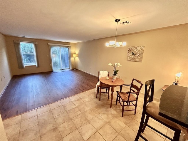 97 Anderer Ln Unit 105, Boston, MA 02132 - dining area featuring visible vents, baseboards, wood finished floors, and an inviting chandelier