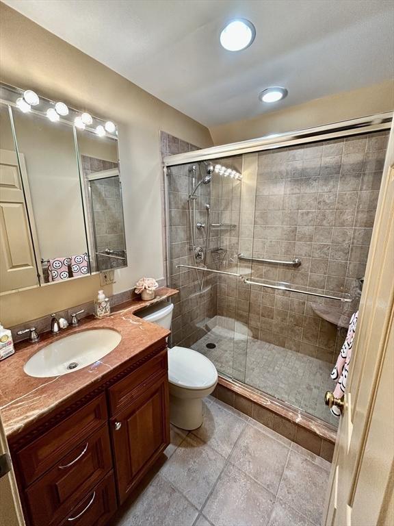 97 Anderer Ln Unit 105, Boston, MA 02132 - bathroom with vanity, toilet, recessed lighting, and a stall shower