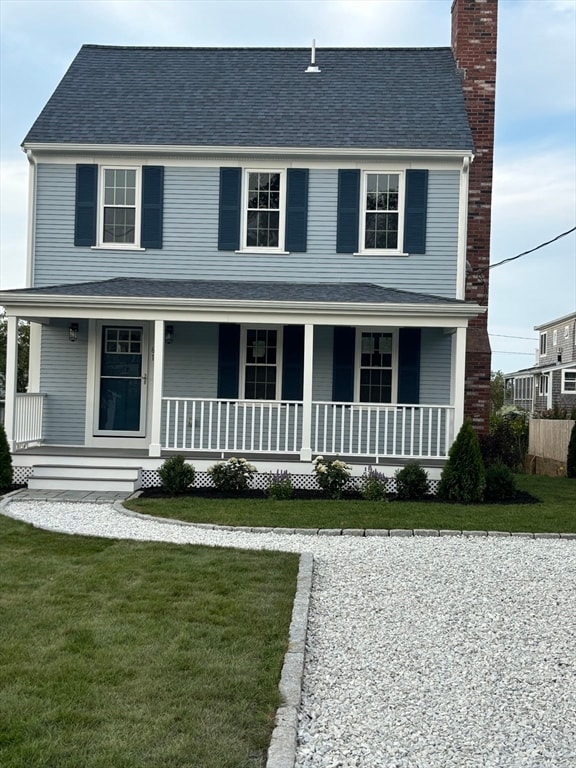 view of front facade with a front lawn and a porch