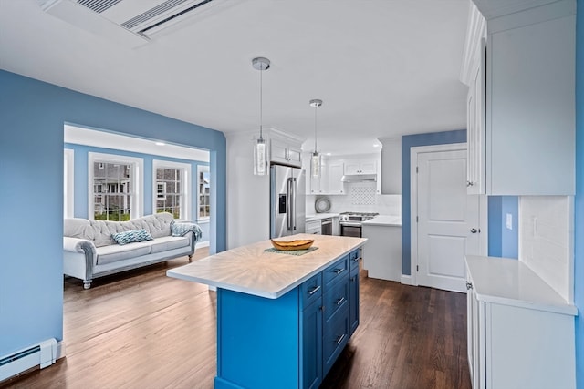 kitchen with white cabinets, stainless steel refrigerator with ice dispenser, a kitchen island, decorative light fixtures, and blue cabinets