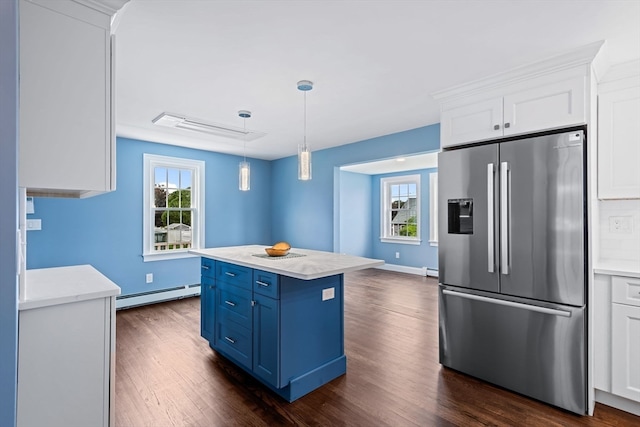 kitchen featuring stainless steel fridge, blue cabinets, white cabinetry, dark hardwood / wood-style flooring, and a baseboard heating unit