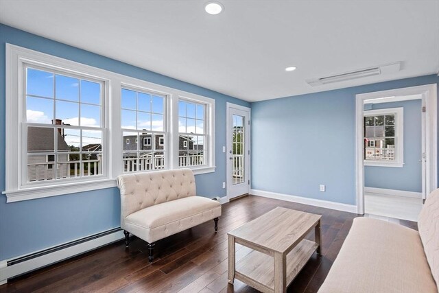 unfurnished bedroom featuring a baseboard radiator, a closet, and dark wood-type flooring