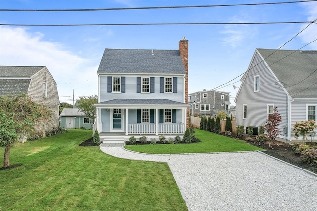 view of front of property featuring central AC unit, a porch, and a front lawn