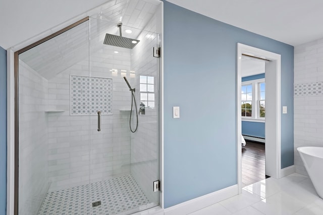 bathroom with independent shower and bath, a baseboard radiator, and tile patterned floors