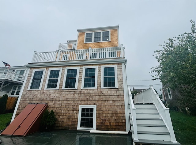 back of property with a balcony