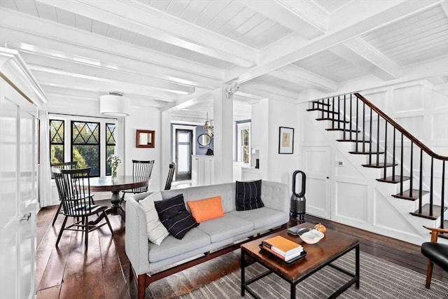 living room with beamed ceiling, ornamental molding, and dark hardwood / wood-style floors