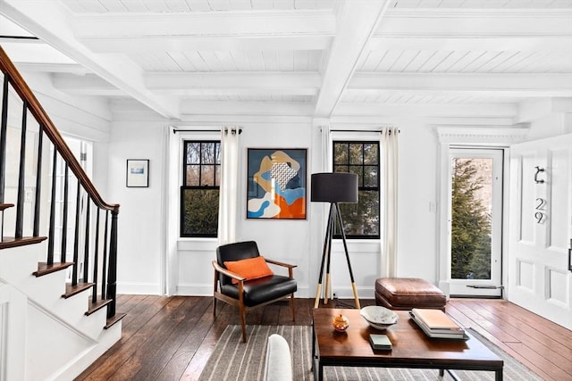 living area with beamed ceiling and dark hardwood / wood-style flooring