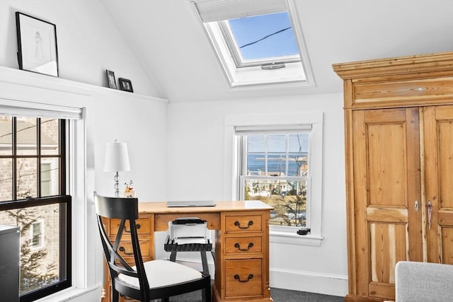 office featuring lofted ceiling with skylight and a wealth of natural light