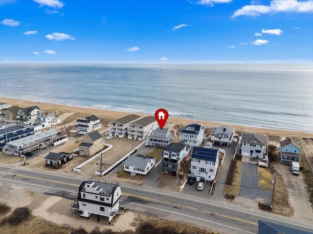 drone / aerial view featuring a water view and a view of the beach