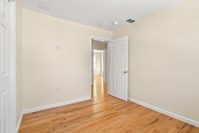 unfurnished bedroom with light wood finished floors and baseboards