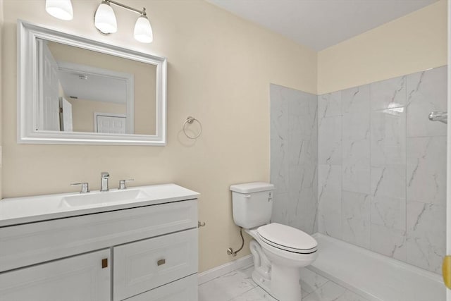 bathroom featuring marble look tile flooring, toilet, vanity, baseboards, and a shower