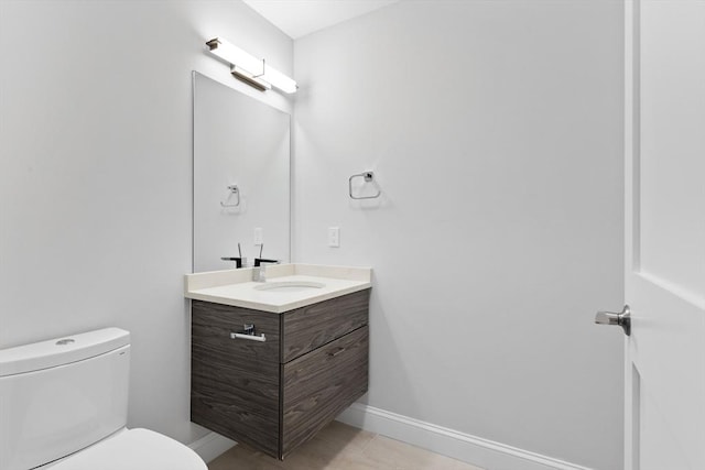 bathroom featuring tile patterned floors, toilet, and vanity