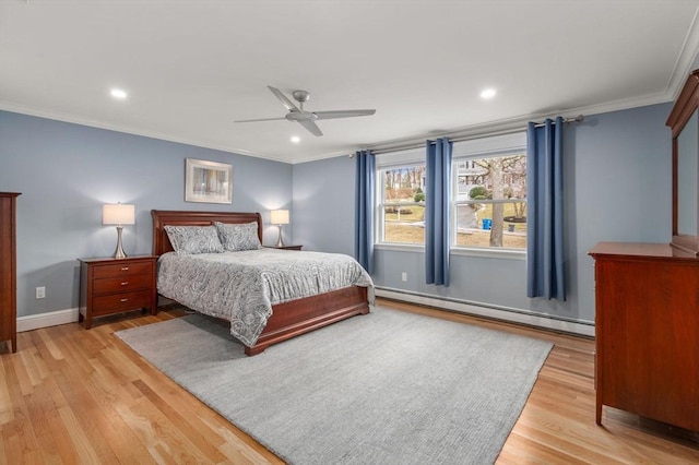 bedroom with crown molding, baseboard heating, baseboards, and light wood-style floors