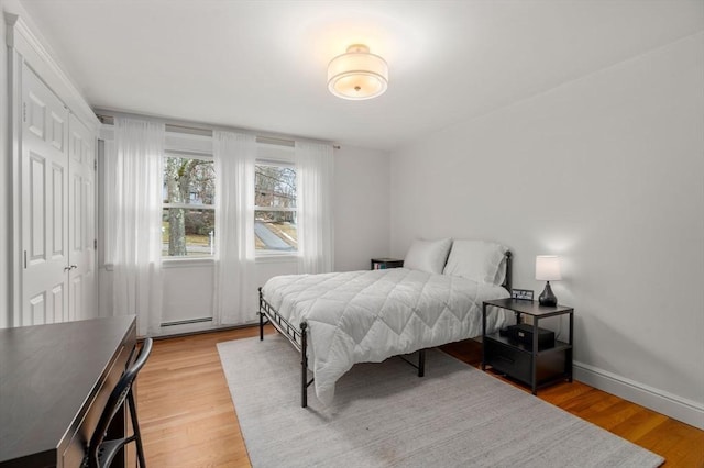 bedroom featuring baseboards and light wood-style floors