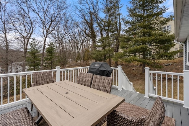 deck featuring outdoor dining area and a grill