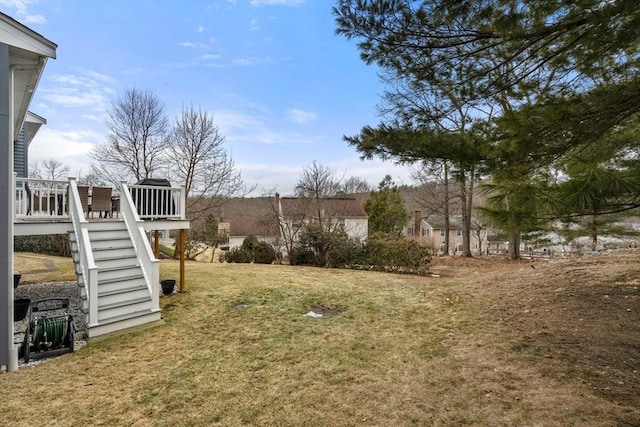 view of yard with a wooden deck and stairs