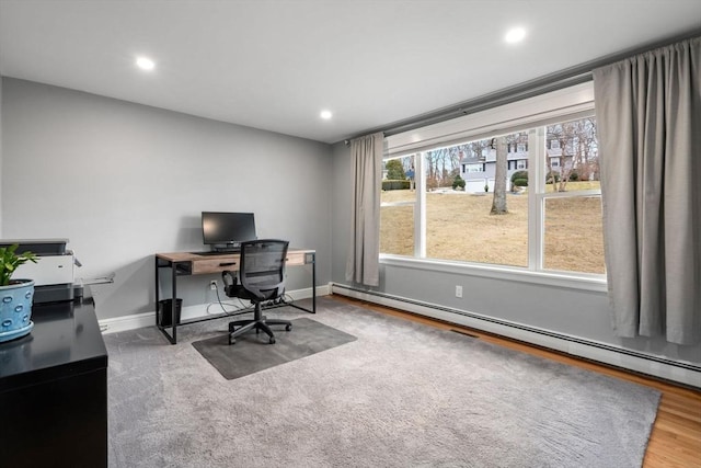 office space with baseboards, baseboard heating, wood finished floors, and recessed lighting