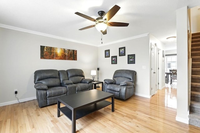 living room with stairs, ceiling fan, baseboards, and light wood-style flooring