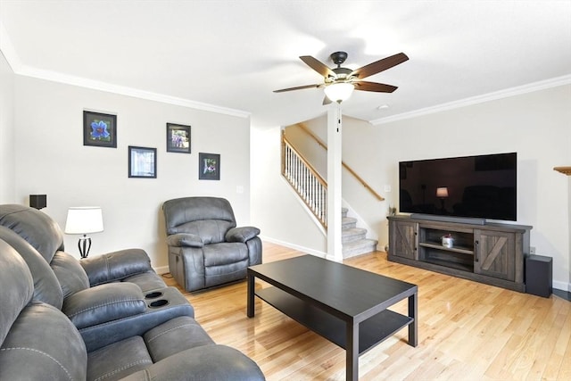 living area with stairs, ceiling fan, and crown molding