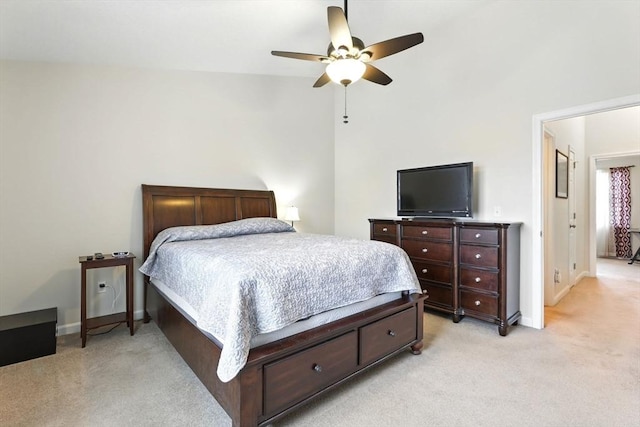 bedroom featuring light colored carpet, a ceiling fan, and baseboards