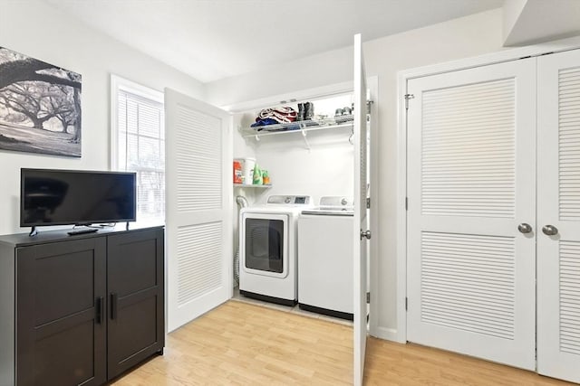 laundry area featuring light wood-style floors, laundry area, and washing machine and clothes dryer