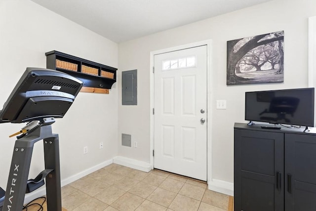 foyer with baseboards, light tile patterned floors, and electric panel